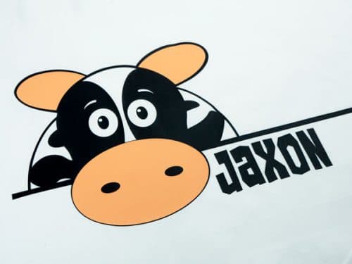 A cute cow with the name "Jaxon" on a pillowcase- the cow is made from ThermoFlex® Plus Matte in Black and Peach