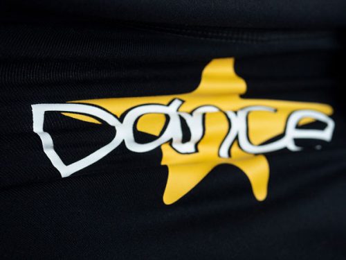 A stretchy garment with the word "Dance" on it over a star being stretched made with White and Yellow ThermoFlex® Stretch HTV