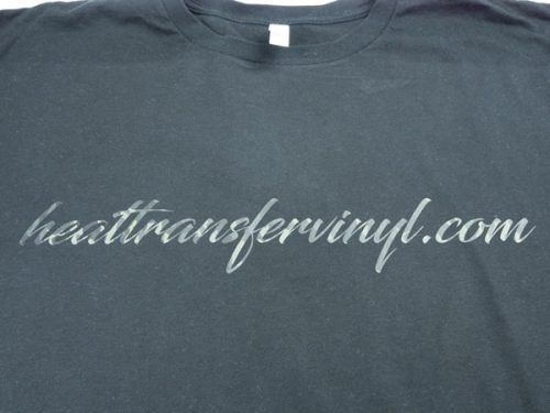 A shirt with a scripty font that reads "heattransfervinyl.com" in Earthtone Camo DecoFilm® Soft Metallics