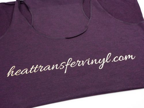 A shirt with the words "heattransfervinyl.com" in a scripty font made in Light Gold DecoFilm® Soft Metallics