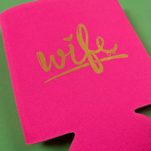 A hot pink koozy with the word "wife" in Gold ThermoFlex® Turbo Brights