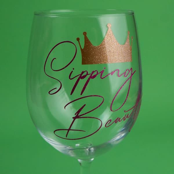 A wine glass that says "Sipping Beauty" in Gold and Pink Ultra Metallic Opaque SpecialtyPSV™