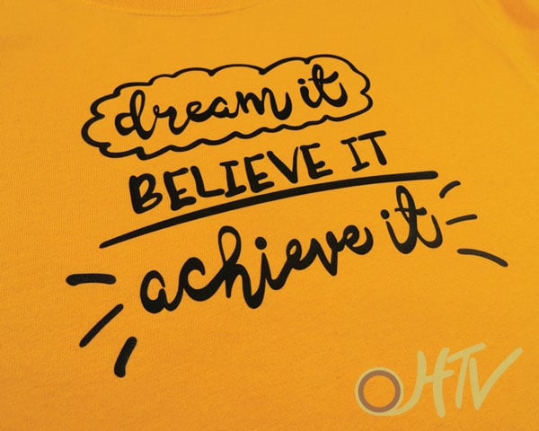 A fun angle of the Dream It Believe It Achieve It shirt