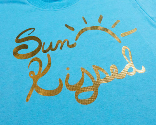 The sun kissed cut file on a shirt made with Light Gold Embossed DecoFilm®