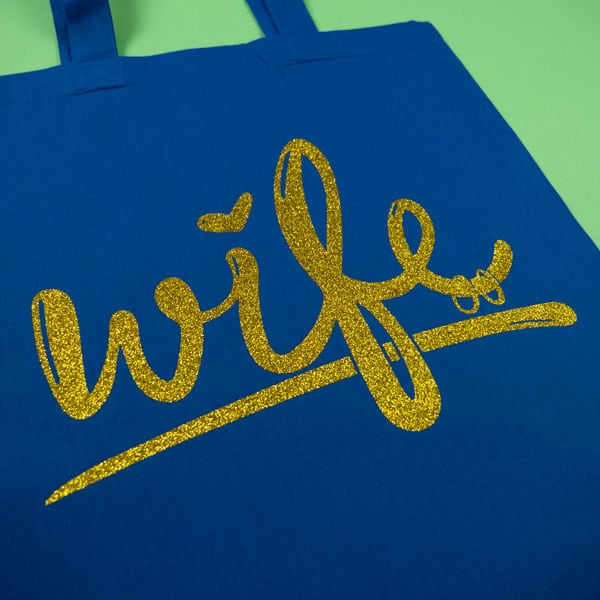 A bag pressed with Gold GlitterFlex® Premium in our Wife cut file