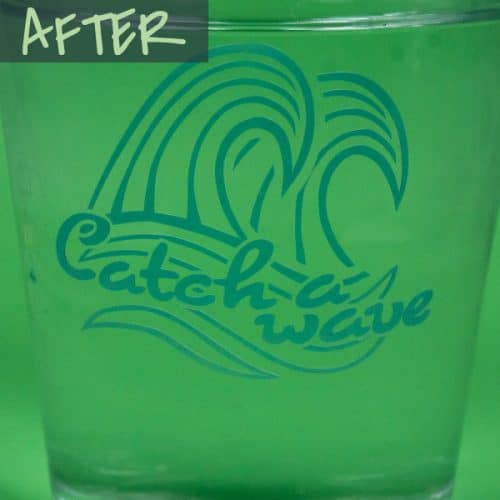 A glass of cold water with a design that says "Catch a wave" in Cold Blue Color Changing SpecialtyPSV™ after the cold water changes the color