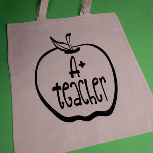 A tote bag with our A+ Teacher cut file made with Black ThermoFlex® Plus Matte