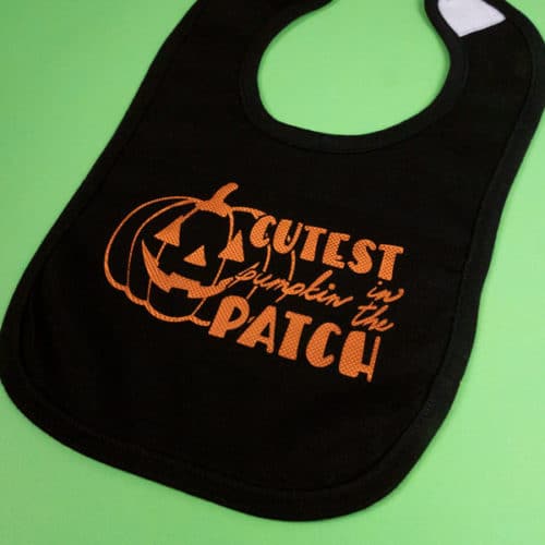 A bib made with our Cutest Pumpkin in the Patch cut file made in Copper Embossed DecoFilm®